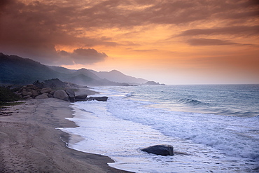 A deserted beach in Tayrona National Park under a golden sunset, Magdalena, Colombia, South America