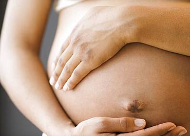 Close up of pregnant African American woman's belly