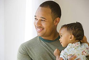 African American father holding baby