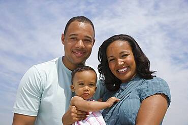 African American parents and baby outdoors