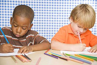 Two young boys coloring