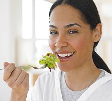 African woman eating salad