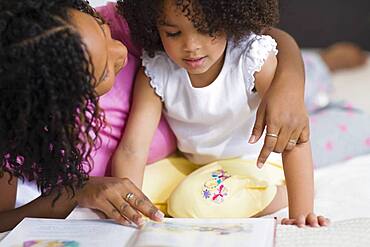 African mother reading to daughter