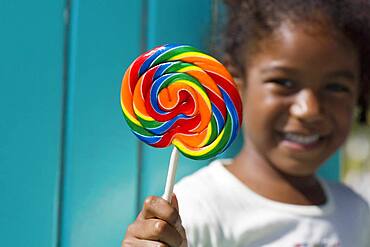 African girl holding lollipop