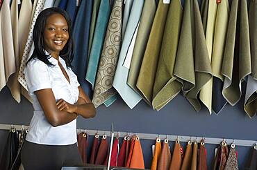 African woman next to fabric swatches