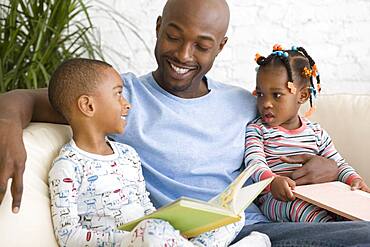 African father reading to children