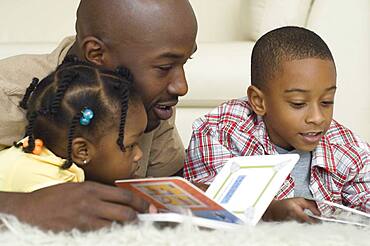 African father reading with children