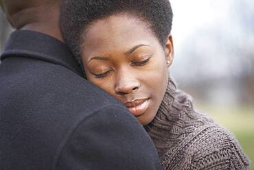 Close up of African couple hugging