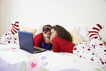 African twin sisters watching movie