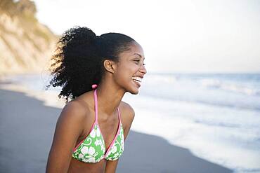 African woman laughing at beach