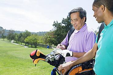 Multi-ethnic men on golf course