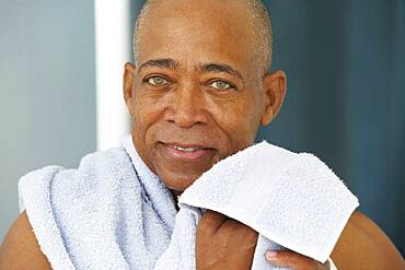 Close up of senior African man with towel