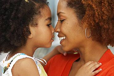 Mother and daughter touching noses