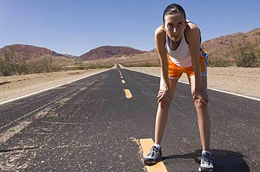 Mixed Race female runner on road