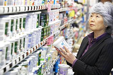 Senior Asian woman shopping in grocery store