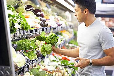 Hispanic man shopping for produce