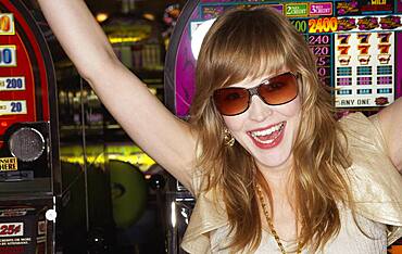 Young woman wearing sunglasses in a casino