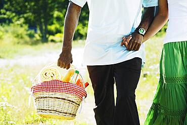 African couple carrying picnic basket