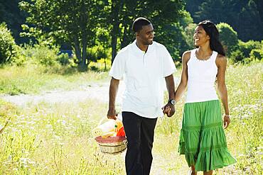 African couple carrying picnic basket