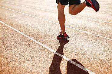 Male athlete running on a track