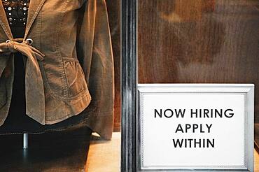 Now Hiring sign in store window