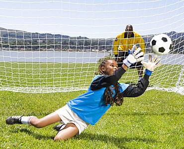 Mixed Race girl playing soccer