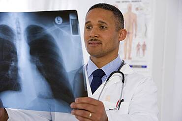 African doctor looking at x-ray