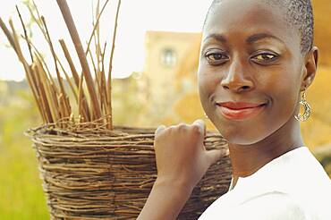 African American woman carrying basket outdoors