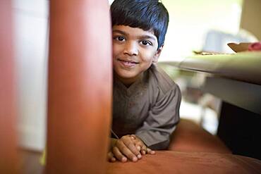 Indian boy laying on floor