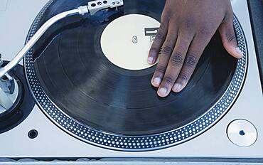 Man spinning vinyl on a turntable