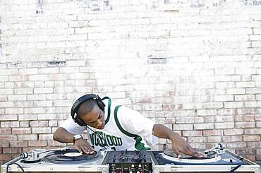 Teenage boy using turntables and headphones