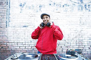 Teenage boy using turntables and headphones