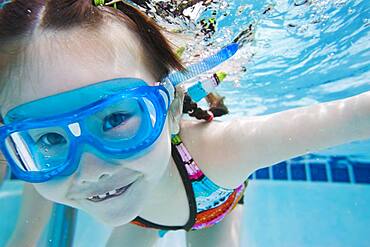 Asian girl swimming under water