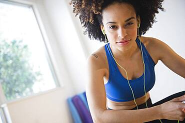 Mixed race woman listening to headphones