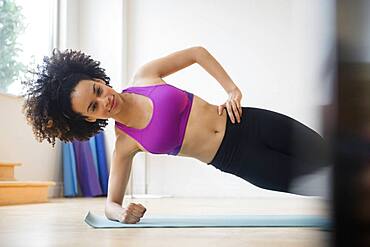 Mixed race woman working out in gymnasium