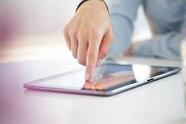 Mixed race woman using digital tablet