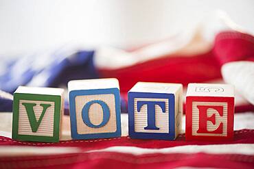 Close up of vote toy blocks on American flag