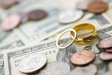 Close up of wedding rings with money