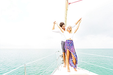 Couple dancing on deck of sailboat