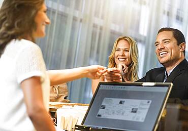 Couple checking in to hotel with concierge