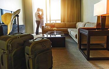 Couple hugging in hotel room