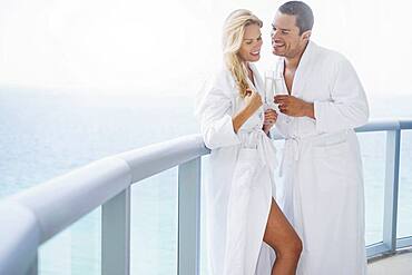 Couple drinking champagne on balcony