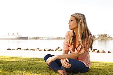 Caucasian woman sitting in park