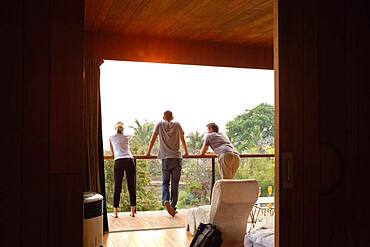 Friends standing on balcony