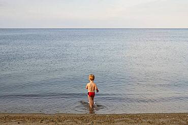 Caucasian boy playing on beach