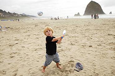 Caucasian boy playing on beach