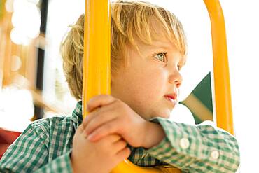 Caucasian boy on play structure in playground