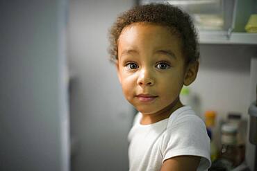 Mixed race boy exploding refrigerator