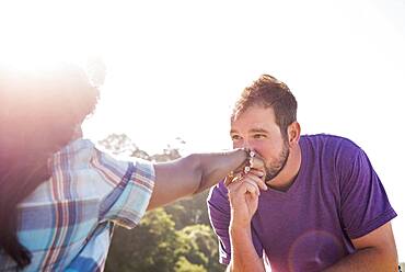 Man kissing hand of girlfriend