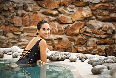 Hispanic woman swimming in pool